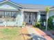 Inviting entryway with a secure wrought iron gate and lush tropical landscaping at 3250 Dellbrook Dr, Deltona, FL 32738