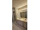 Bathroom with double vanity and large mirror at 32712 Timberwood Dr, Leesburg, FL 34748