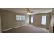 Spacious bedroom with ceiling fan and window coverings at 32712 Timberwood Dr, Leesburg, FL 34748