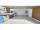Spacious garage with pegboard, workbench, and extra storage at 32712 Timberwood Dr, Leesburg, FL 34748
