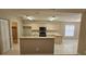 Galley style kitchen with light wood cabinets and tile floor at 32712 Timberwood Dr, Leesburg, FL 34748