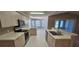 Kitchen with ample counter space, stainless steel appliances, and view to dining area at 32712 Timberwood Dr, Leesburg, FL 34748