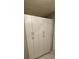 White cabinets offer great storage in this laundry room at 32712 Timberwood Dr, Leesburg, FL 34748