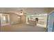 Open living and kitchen area with neutral colors and carpeting at 32712 Timberwood Dr, Leesburg, FL 34748