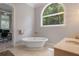 Bathroom with freestanding tub and garden view at 3413 Lilas Ct, Windermere, FL 34786