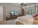 Bright bedroom with large TV and access to pool at 3413 Lilas Ct, Windermere, FL 34786