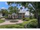 House with metal roof, circular driveway, and lush landscaping at 3413 Lilas Ct, Windermere, FL 34786