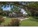 Two-story home with circular driveway and manicured lawn at 3413 Lilas Ct, Windermere, FL 34786