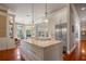Gourmet kitchen with white cabinets, marble island, and stainless steel appliances at 3413 Lilas Ct, Windermere, FL 34786