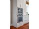 Built-in wall oven and microwave in a white kitchen at 3413 Lilas Ct, Windermere, FL 34786