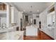 Elegant kitchen with white cabinets, marble countertops, and high-end appliances at 3413 Lilas Ct, Windermere, FL 34786