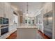 Spacious kitchen with island, stainless steel appliances, and white cabinetry at 3413 Lilas Ct, Windermere, FL 34786
