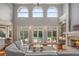 Spacious living room with fireplace, high ceilings, and access to pool at 3413 Lilas Ct, Windermere, FL 34786