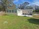 Tan house with a patio, sunroom and a fenced backyard at 3745 Mount Tabor Rd, Lakeland, FL 33810