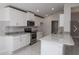 Modern kitchen featuring white cabinets, granite countertops, and stainless steel appliances at 4284 Sagefield Drive, St Cloud, FL 34773