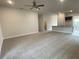 Spacious living room with neutral carpeting, ceiling fan, and open concept design at 4306 Sagfefield, St Cloud, FL 34773