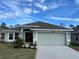 Single-story house with a two-car garage and front landscaping at 4312 Sagefield Drive, St Cloud, FL 34773