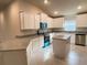 Modern kitchen with white cabinets, granite countertops, and an island at 4312 Sagefield Drive, St Cloud, FL 34773