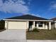 Newly constructed home with a two-car garage and well-manicured lawn at 4486 Segafield, St Cloud, FL 34773