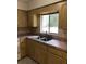 Kitchen sink and countertops with wood cabinets at 4800 Beacon St, Orlando, FL 32808