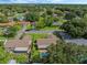 Aerial view of house with pool and lush green surroundings at 5405 Justine Way, Winter Park, FL 32792