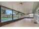 The screened porch offers an extended view of the refreshing pool and landscaped backyard at 5405 Justine Way, Winter Park, FL 32792