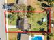 Aerial view featuring an ample-sized, grassy backyard with a pool nearby and bordered by trees at 754 Canovia Ave, Orlando, FL 32804