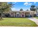 Inviting single-story home with a covered carport and lush green lawn at 754 Canovia Ave, Orlando, FL 32804