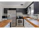 Functional kitchen featuring stainless steel appliances and butcher block countertops at 754 Canovia Ave, Orlando, FL 32804