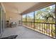 Screened balcony with wooded views and comfortable seating at 8321 Bella Vida Cir # 8321, Davenport, FL 33896