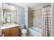 Clean bathroom with tub shower combo and striped curtain at 8321 Bella Vida Cir # 8321, Davenport, FL 33896