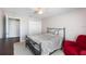 Well-lit bedroom with a comfortable bed and red accent chair at 8321 Bella Vida Cir # 8321, Davenport, FL 33896