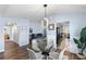 Glass dining table with chairs and an open view to the living room at 8321 Bella Vida Cir # 8321, Davenport, FL 33896