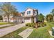 Two-story townhome with a two-car garage and well-manicured landscaping at 8321 Bella Vida Cir # 8321, Davenport, FL 33896