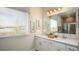 Double vanity bathroom with quartz countertops and a large mirror at 833 Oaks Shores Rd, Leesburg, FL 34748