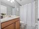 Well-appointed bathroom with wood cabinets, shower, and single sink vanity at 8876 Candy Palm Rd, Kissimmee, FL 34747