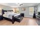 King-size bed in a spacious bedroom with wood floors and plenty of light at 8876 Candy Palm Rd, Kissimmee, FL 34747