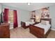 Guest bedroom with two twin beds, hardwood floors, and large window at 8876 Candy Palm Rd, Kissimmee, FL 34747