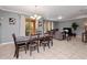 Elegant dining area with dark wood table and access to backyard at 8876 Candy Palm Rd, Kissimmee, FL 34747