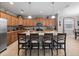 Spacious kitchen with island, light wood cabinets, and granite countertops at 8876 Candy Palm Rd, Kissimmee, FL 34747