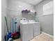 Convenient laundry room with washer, dryer, and shelving at 8876 Candy Palm Rd, Kissimmee, FL 34747