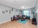 Relaxing living room with a sectional sofa and wood-look floors at 8876 Candy Palm Rd, Kissimmee, FL 34747