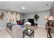 Comfortable living room with tiled floors and access to patio at 8876 Candy Palm Rd, Kissimmee, FL 34747