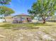 Backyard with large tree, chicken coop, and grassy area at 933 El Lago Ter, Winter Springs, FL 32708