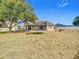 Large backyard with trampoline, patio, and mature trees at 933 El Lago Ter, Winter Springs, FL 32708