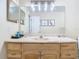 Bathroom with light wood vanity and large mirror at 933 El Lago Ter, Winter Springs, FL 32708