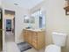 Bathroom with light wood vanity, toilet and access to hallway at 933 El Lago Ter, Winter Springs, FL 32708