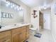 Bathroom with light wood vanity, toilet and bathtub at 933 El Lago Ter, Winter Springs, FL 32708