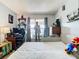 Bedroom with large bed, suit of armor, and gaming setup at 933 El Lago Ter, Winter Springs, FL 32708