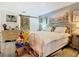 Primary bedroom with king bed, barn door, and calm decor at 933 El Lago Ter, Winter Springs, FL 32708